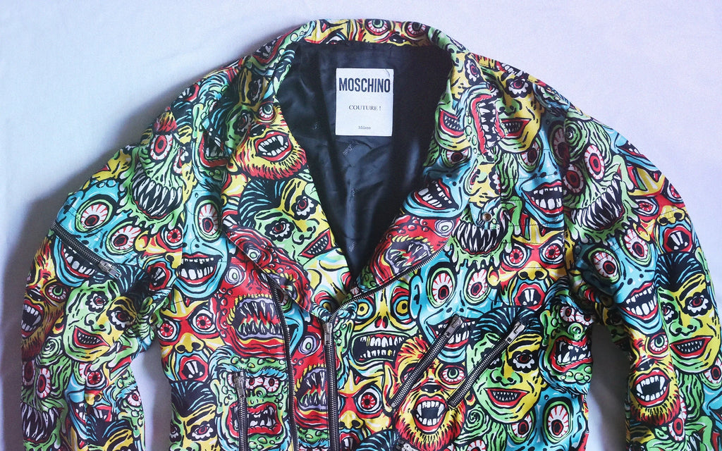 Moschino couture jacket with multicolor grotesque face prints, iconic creation by Italian fashion designer Franco Moschino.