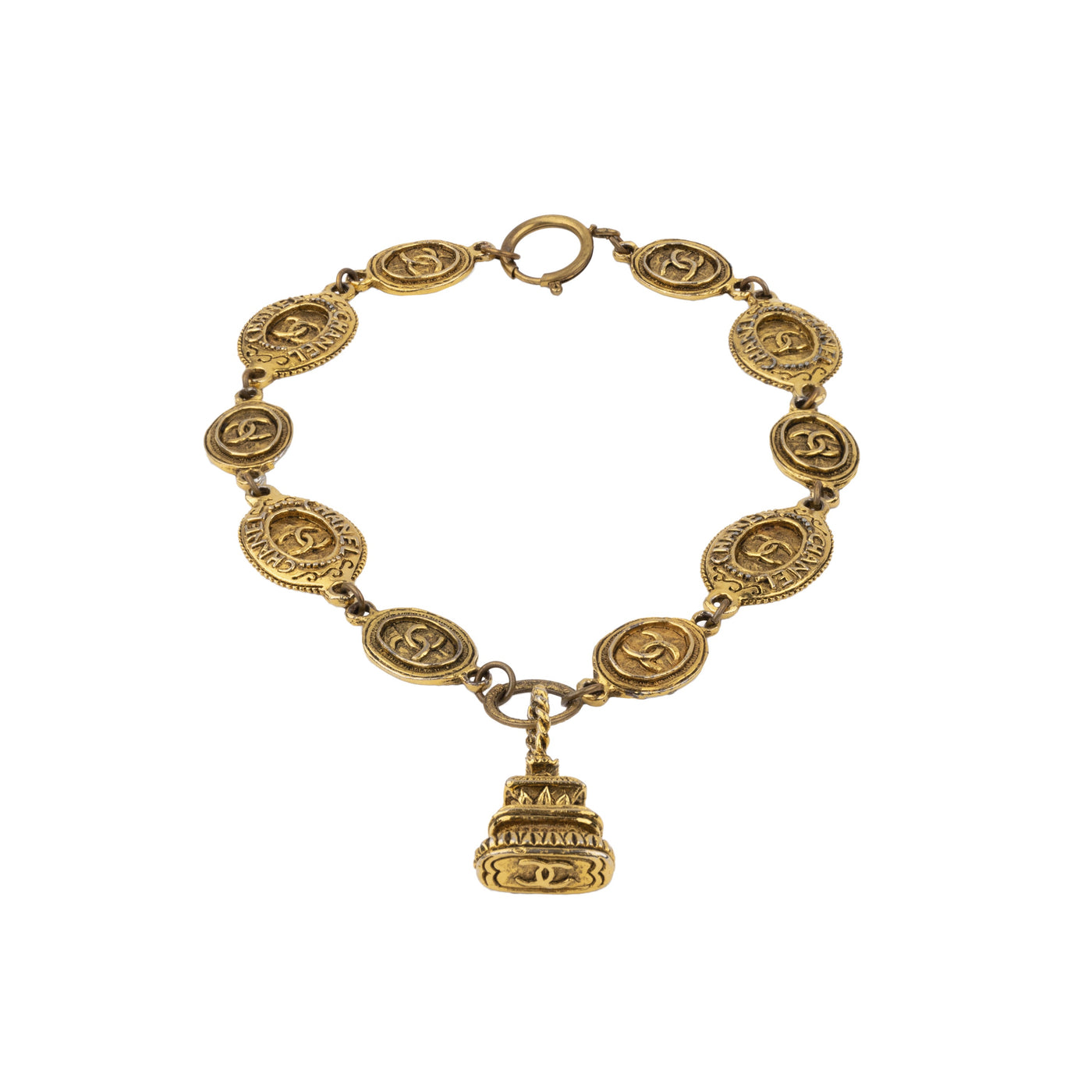 Chanel gold-plated brass necklace. This is a short necklace with medallions decorated with baroque motifs and crossed CC logo embellished with a pendant which recalls a Buddhist temple in its shape pre-owned
