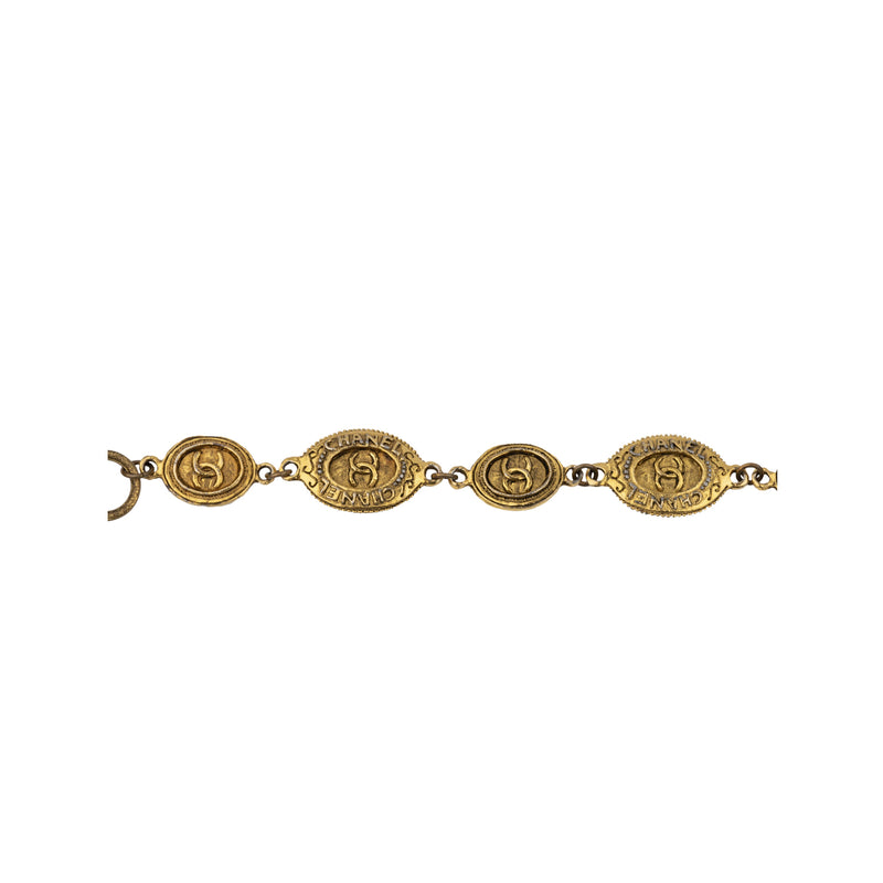 Chanel gold-plated brass necklace. This is a short necklace with medallions decorated with baroque motifs and crossed CC logo embellished with a pendant which recalls a Buddhist temple in its shape pre-owned